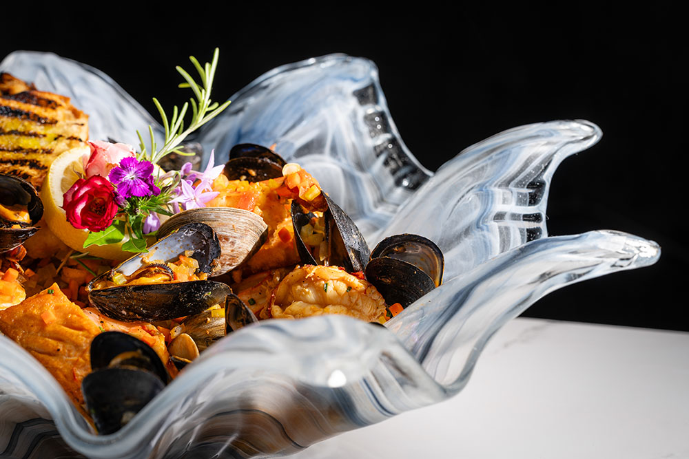 Seafood stew with clams, mussels, and fresh catch in a saffron–tomato broth.